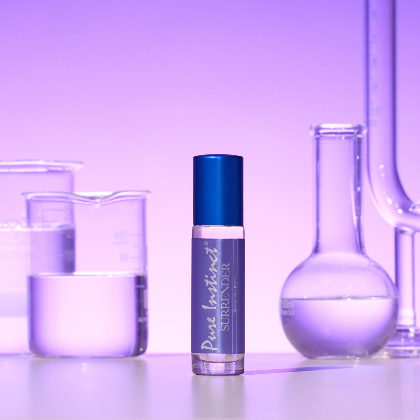 Surrender Roll-On Pheromone Perfume Oil standing among scientific beakers and flasks under a violet glow, highlighting a clean and sophisticated vibe