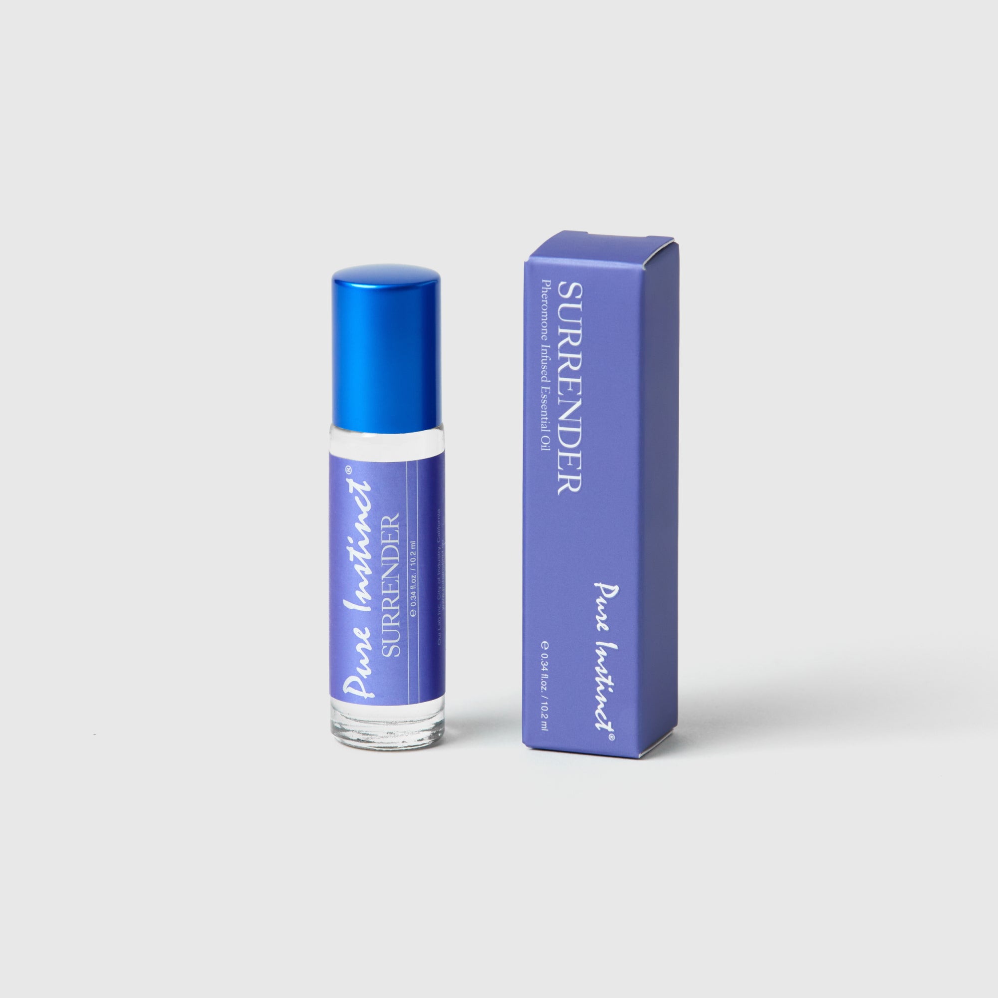 Surrender Roll-On Pheromone Perfume Oil bottles arranged on a white surface with one opened to display the roll-on applicator