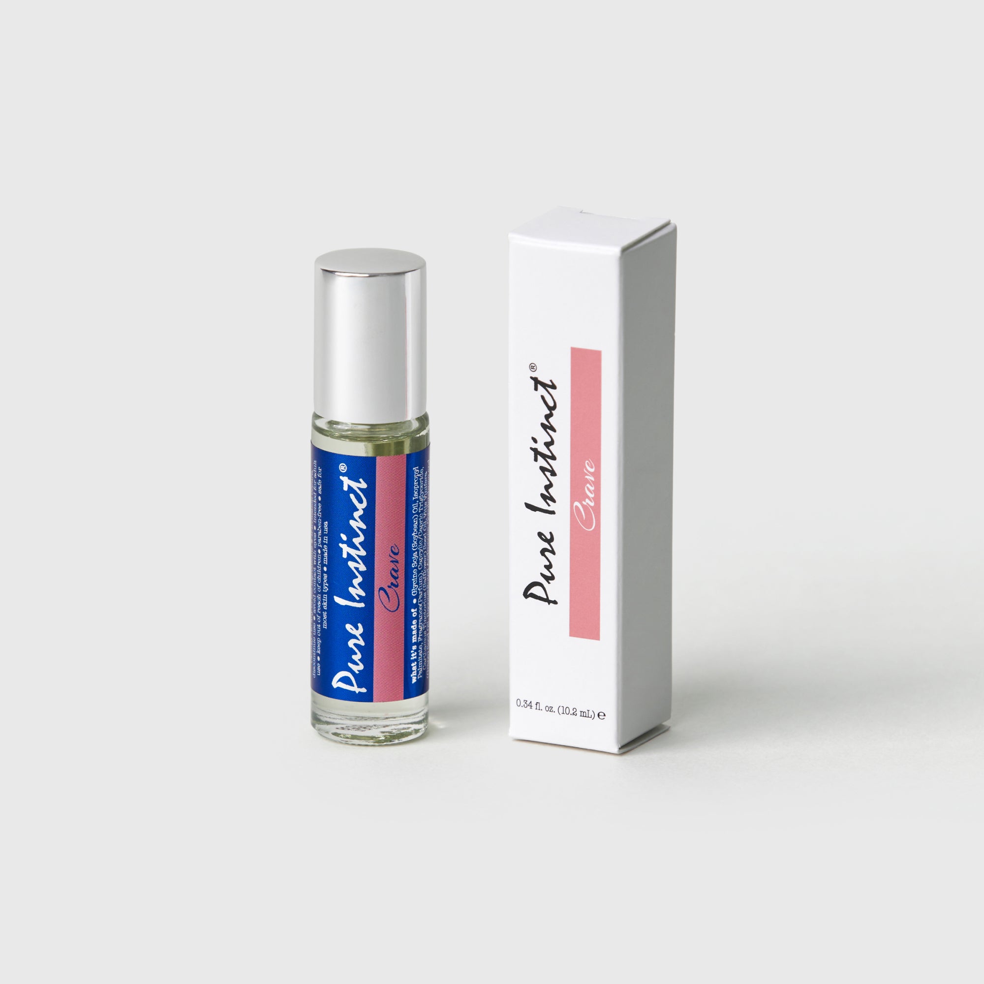 Pure Instinct Crave Roll-On Pheromone Perfume Oil standing elegantly on a soft-toned pedestal, showcasing its sleek design and bold gradient label.